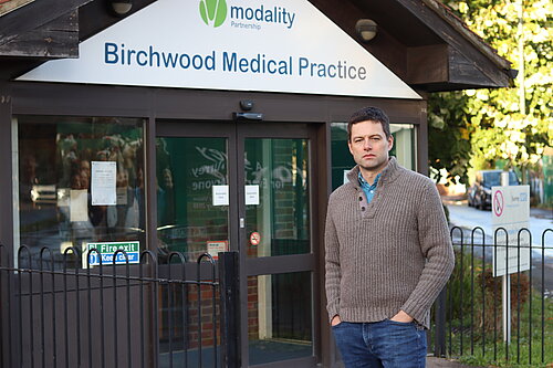 Chris in front of medical practice