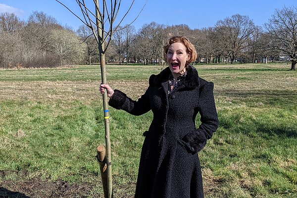 Claire planting a tree